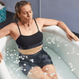 A woman sitting in an inflatable ice bath