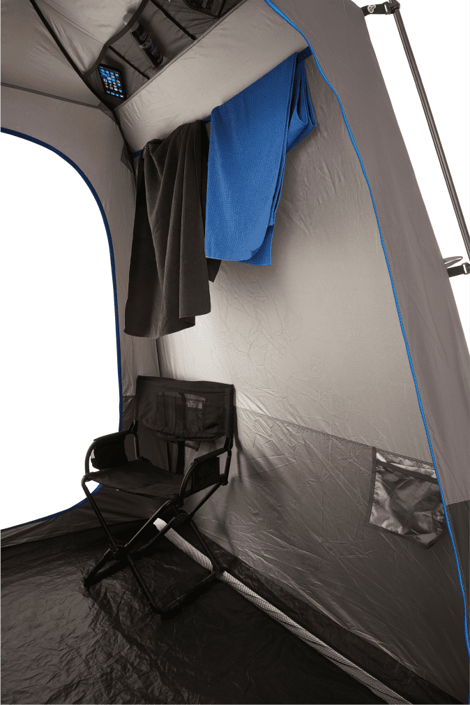 An internal look at the tent with two towels hanging and a camper chair