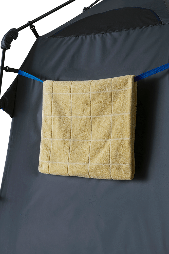 An external look at a yellow towel hanging outside a tent