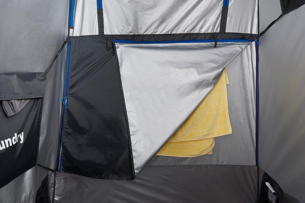 An internal look at a yellow towel hanging inside a tent being partially covered