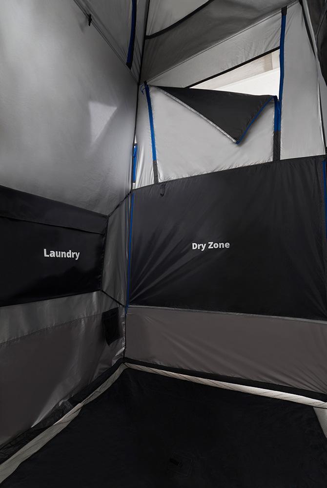 An internal look at the shower tent displaying the dry zone cover and laundry basket to keep items dry