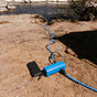 A water pump being powered by a power bank that is pumping up water from a river around 20 metres away