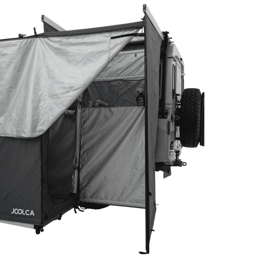 Internal view of a mounted double shower tent with one door open and two indistinct cosmetic items