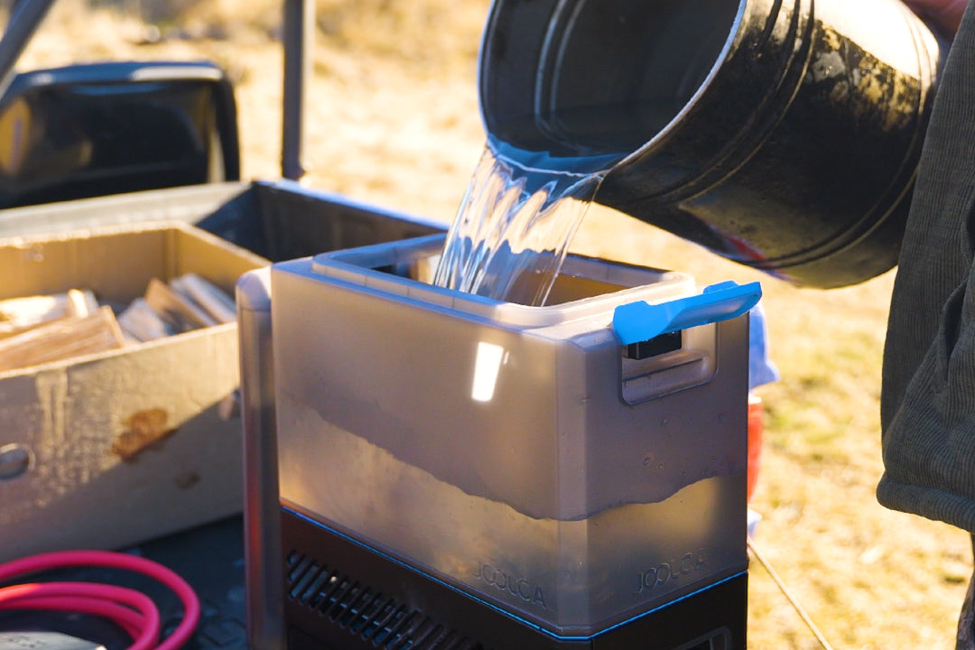 Water being poured from a bucket into the HOTTAP Go reservoir
