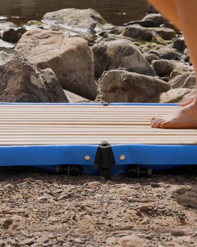 Bare feet standing on the wet Joolca Shower Base as water drains away cleanly